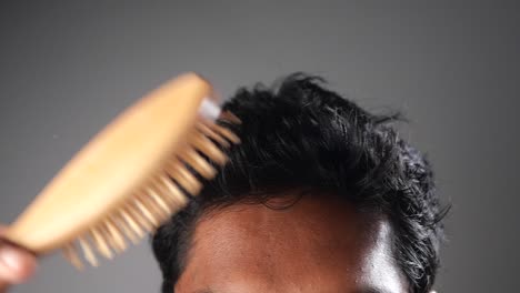 man combing his hair
