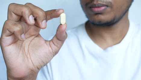 person holding a pill