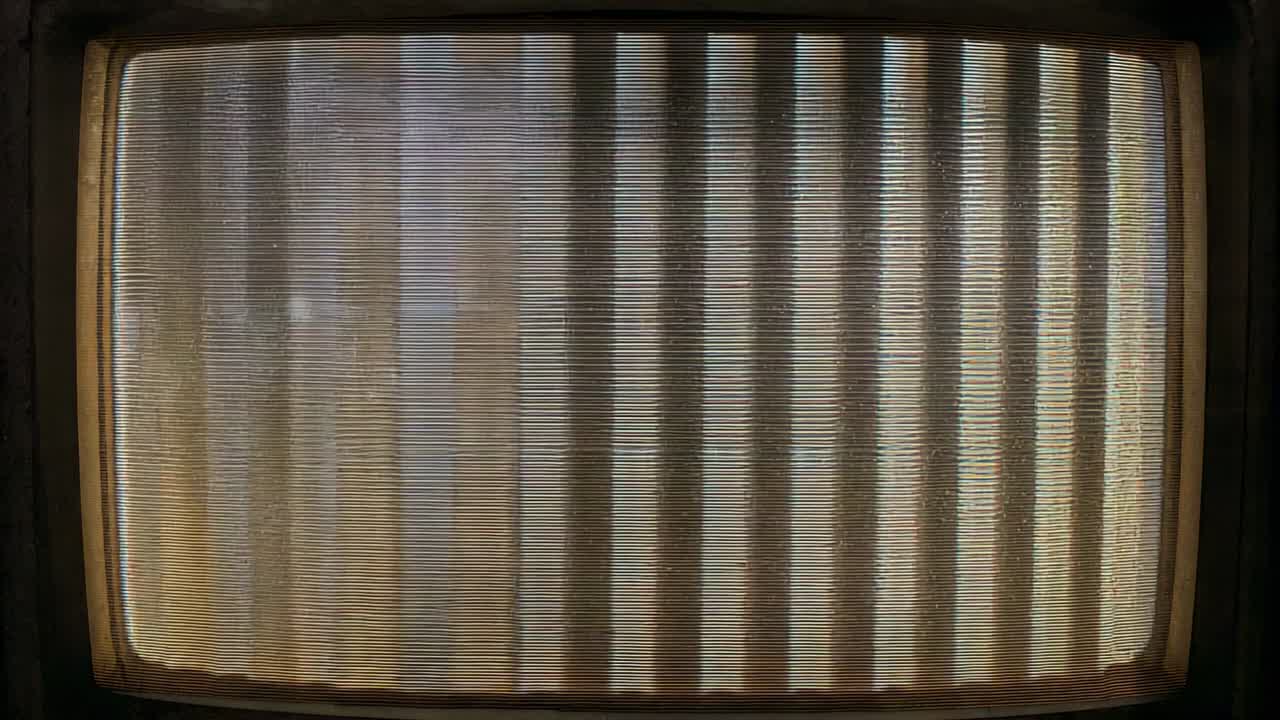 Shifting light nudging window with vertical blinds, showing screen and floating dust in dim room