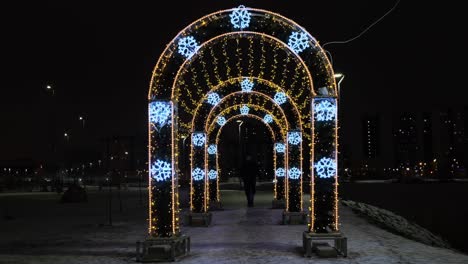 illuminated archway in a winter city park