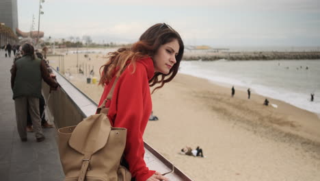 young girl looking at something on the seafront