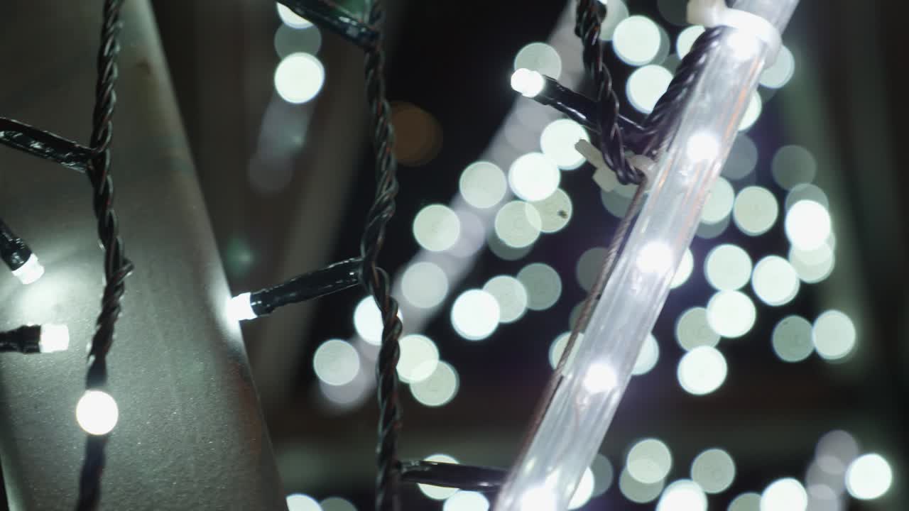 Christmas garland with Golden lights, close-up. Blurred Christmas lights. Bokeh