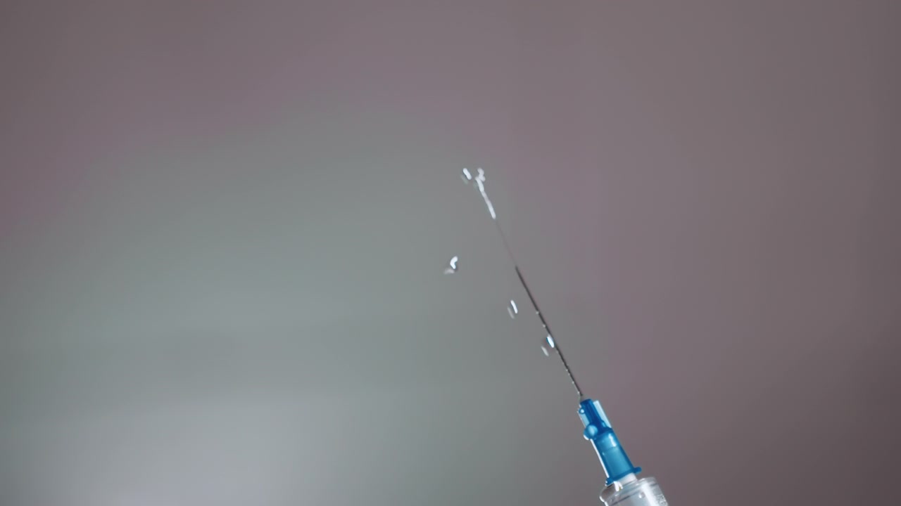 Syringe poised operating room black anesthesiologist, sterile needle angled toward surgical field, soft overhead lights, calm focused atmosphere, anesthesia preparation, team ready, precision