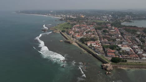 aerial descends to medieval coastal fort stone wall in galle sri lanka