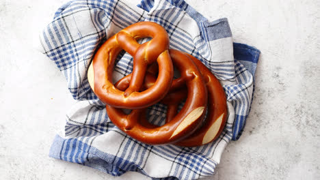 Three-german-fresh-baked-pretzel-buns-placed-on-napkin