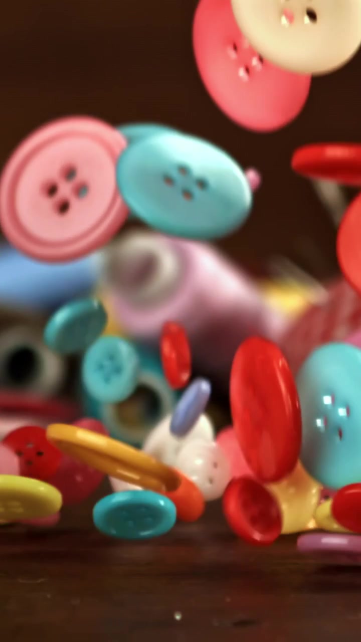 Colorful Sewing Buttons Falling in Slow Motion