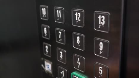 person pressing elevator button to floor 9