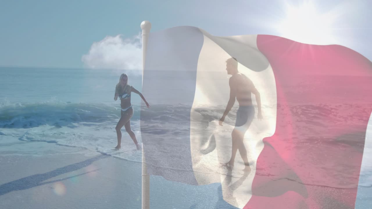 Woman stepping back as wave approaching, man kicking behind sheer flag, travel ad showing leisure