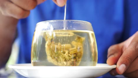 cup of tea with tea bag on wooden table close-up