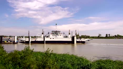 ferry boat carrying vehicles and tourists crosses the rhone in france, video 4k