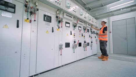 electrical engineers inspect the electrical systems at the equipment control cabinet