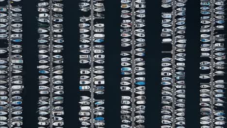 Slow descending shot showing the rows of docked yachts in Shilshole Bay Marina, Seattle