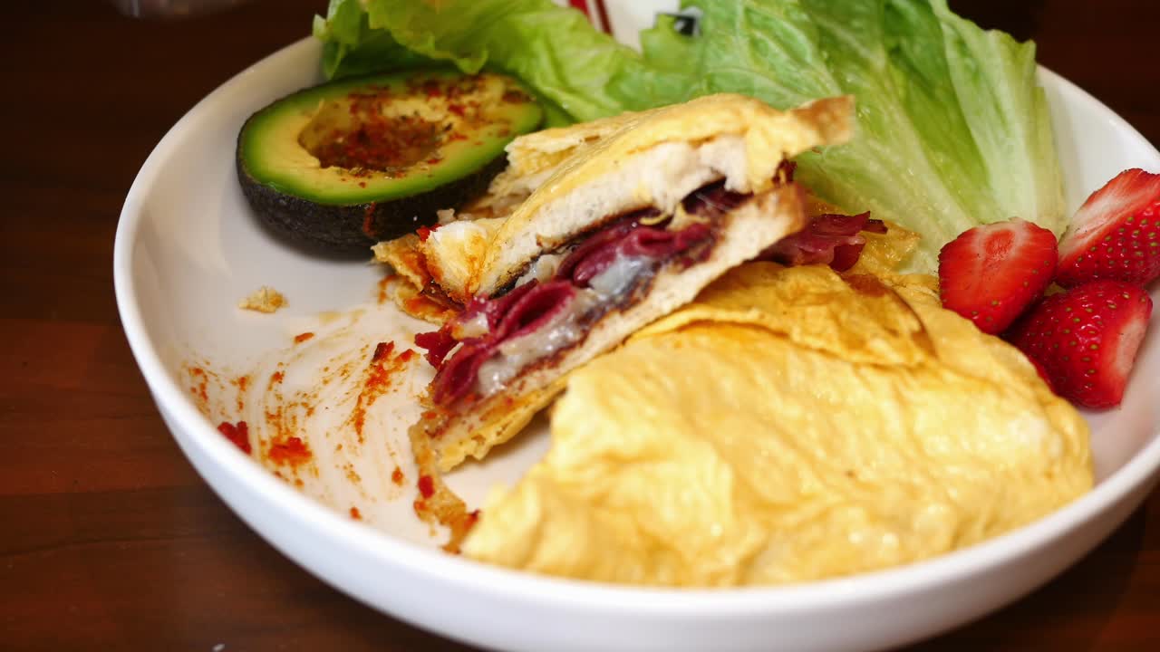 Delicious Breakfast Sandwich with Avocado, Salad, and Strawberries