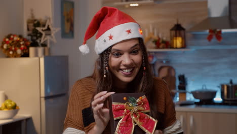 Young-festive-woman-showing-gifts-to-friends