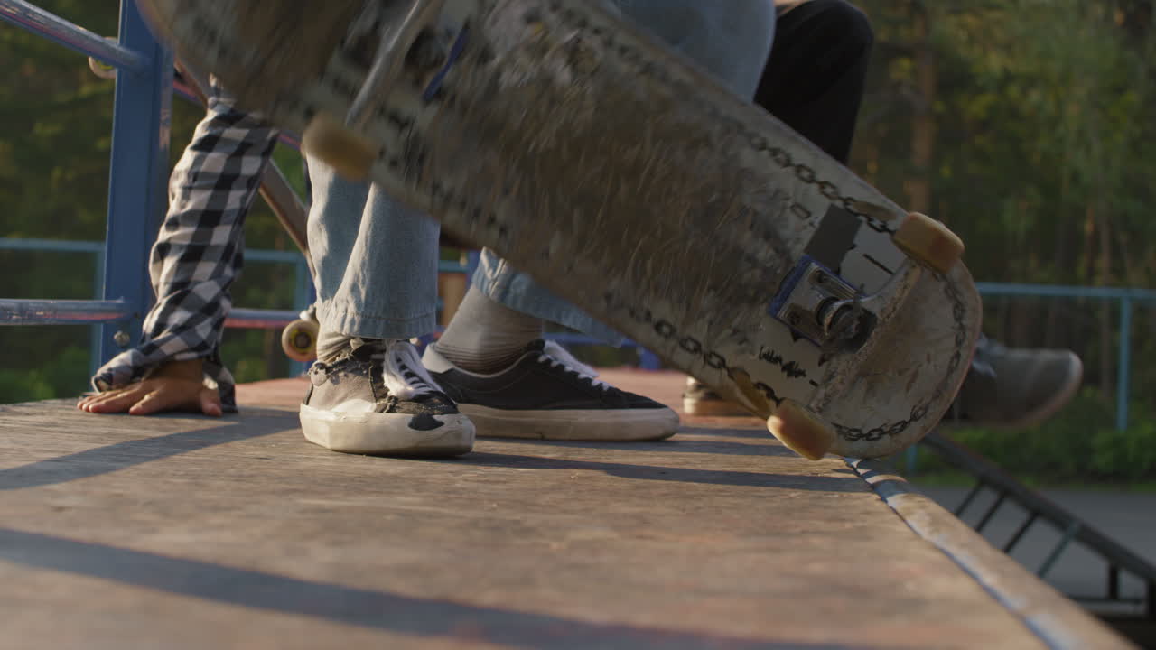 Unrecognizable Teenager Skating Down Ramp
