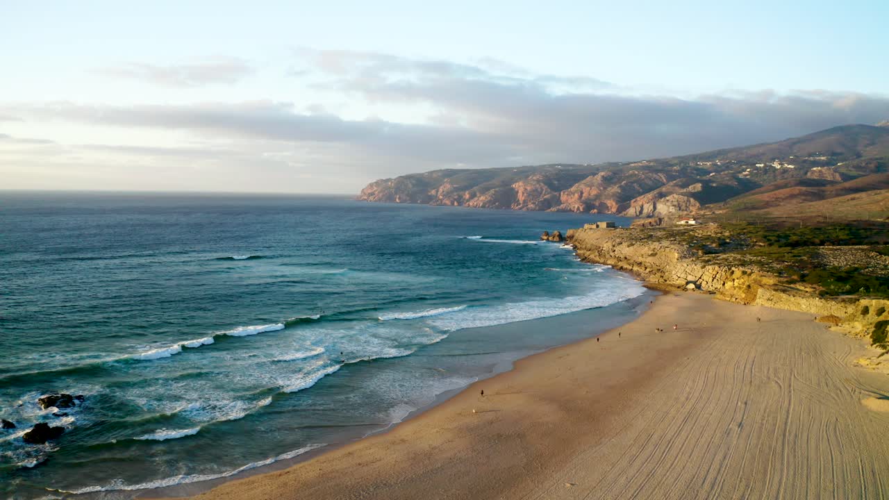 Drone shot of Praia do Guincho at Sunset in Cascais, overlooking the Mountains of Sintra