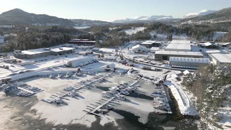 Drone-flies-over-Håhjem-marina-in-Ålesund,-which-has-frozen-over