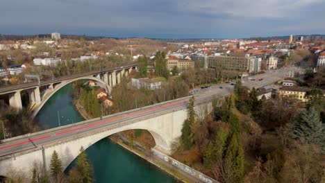 arch bridges for cars and trains leading to bern city center streets