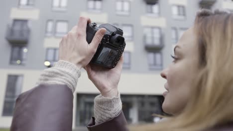 woman taking picture of building