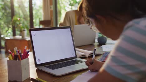 Asian-mother-and-daughter-learning-and-working-using-laptop-with-copy-space