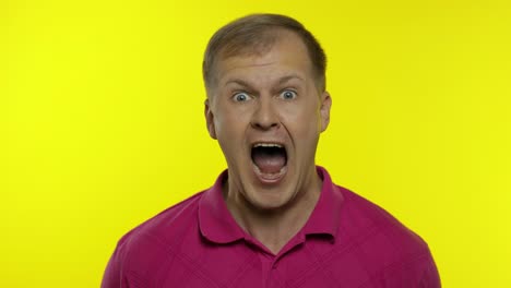 Portrait-of-young-caucasian-man-posing-in-pink-t-shirt.-Amazed-handsome-guy-shocked,-surprised