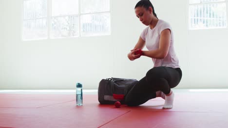 Caucasian-woman-putting-strap-around-her-wrists