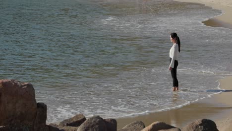 distant view of asian woman on the shore