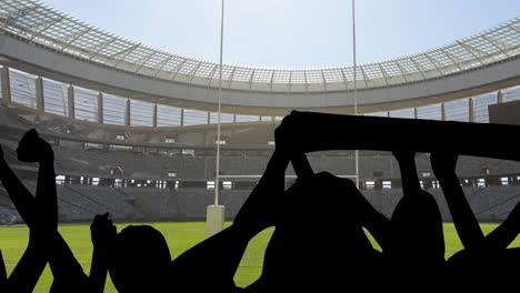 animation of silhouettes of sports fans cheering over sports stadium