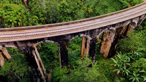 stunning aerial drone footage of the famous nine arches bridge in ella, sri lanka.