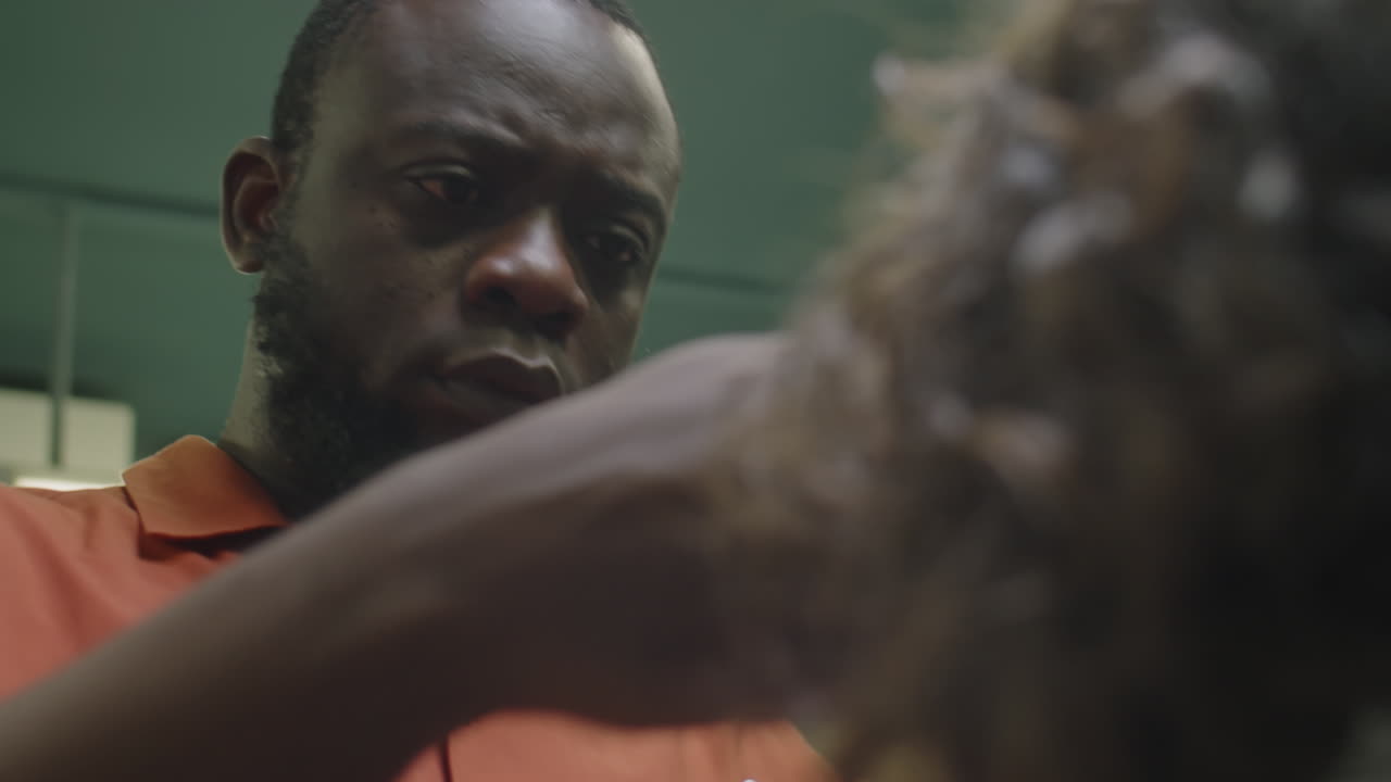 Black Barber Giving Haircut to Client
