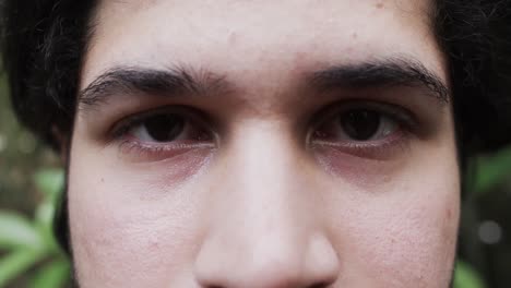 portrait of happy eyes of caucasian man in nature with copy space, slow motion