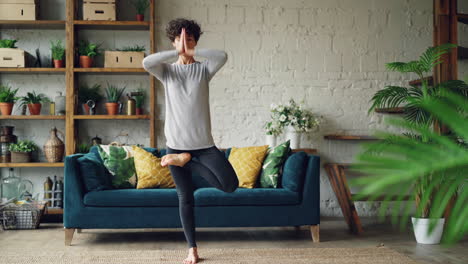 woman practicing yoga in a living room