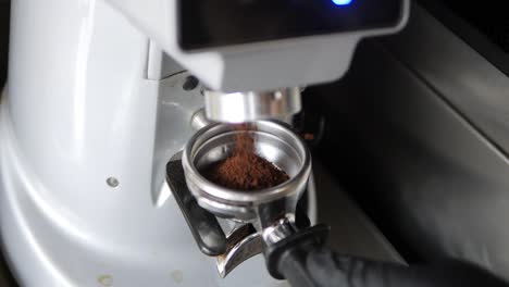 Coffee-Grounds-Filling-Group-Head-From-Coffee-Grinder-Close-Up-Slow-Mo