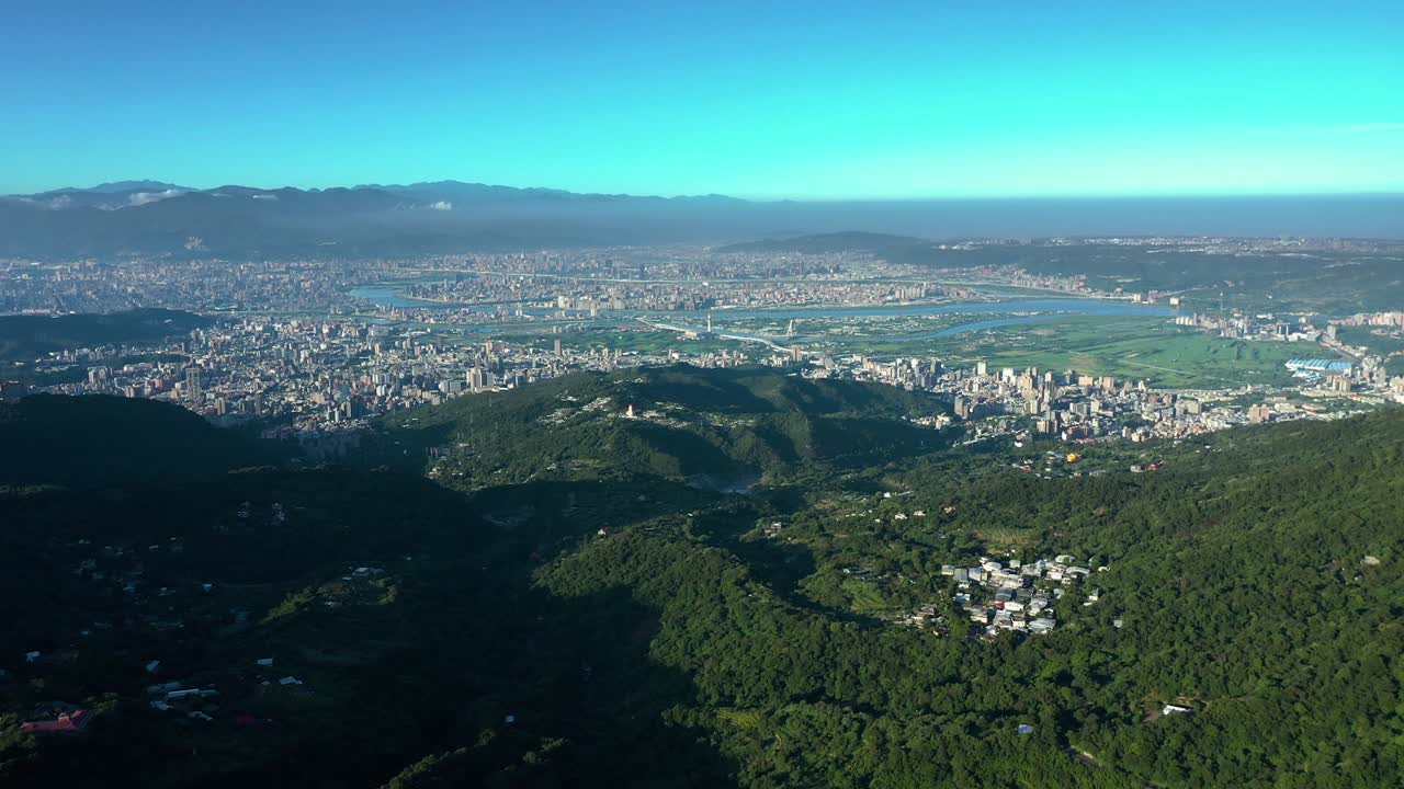 Aerial view from Yangmingshan national park showing Tamshui river and cityscape during blue sky in Taiwan