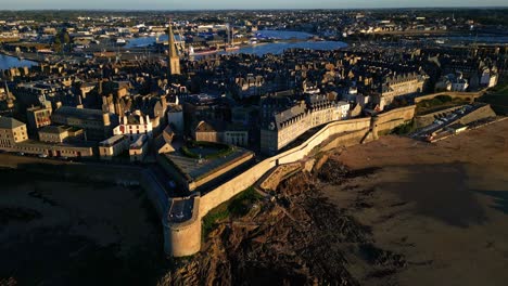 panning drone movement above the intra muros landscape at sunset, saint-malo, france.