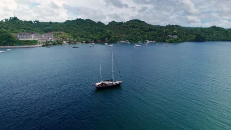 aerial orbit of anchored recreational sailing boat on samana bay, dominican