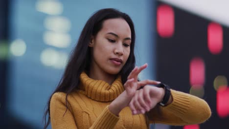 asian woman using smartwatch and smiling