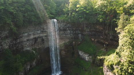 light rays stream through mist above tew falls in ontario canada