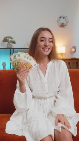 woman holding euro bills and smiling