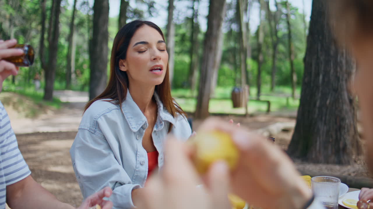 Woman communicating friends picnic sunny day closeup. Happy brunette talking