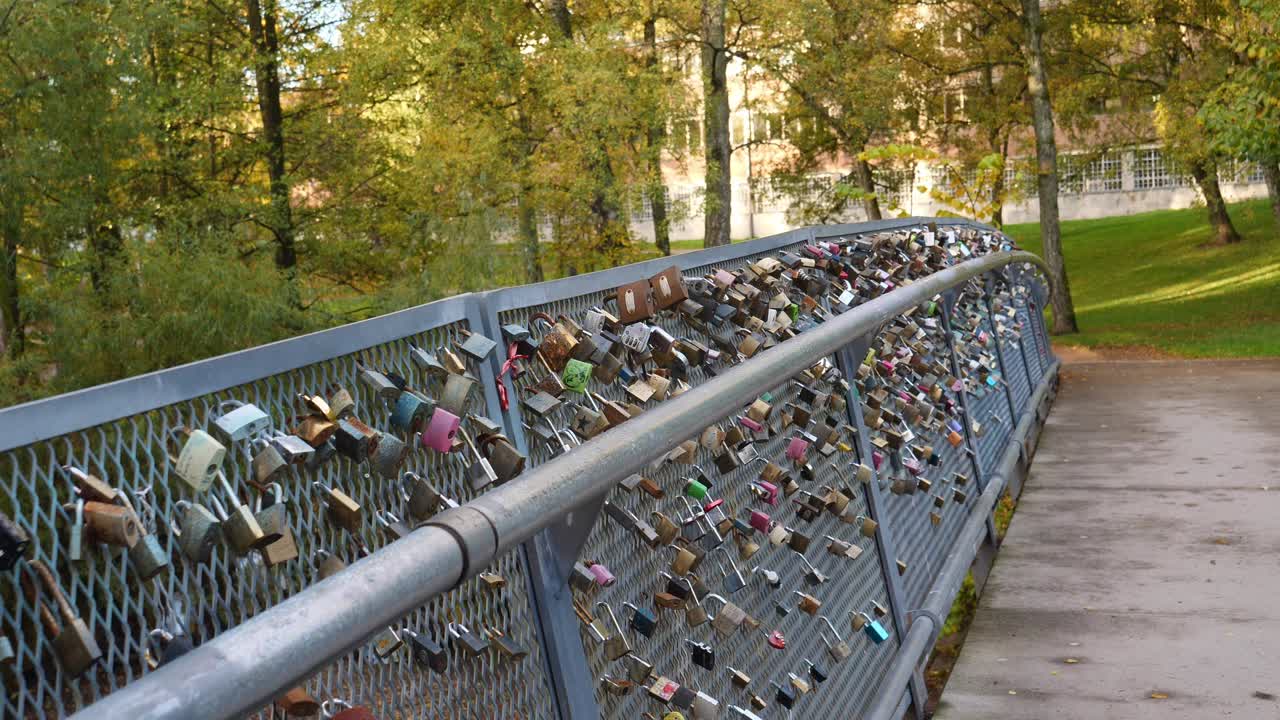Total of a bridge with love locks hanging on it's fence