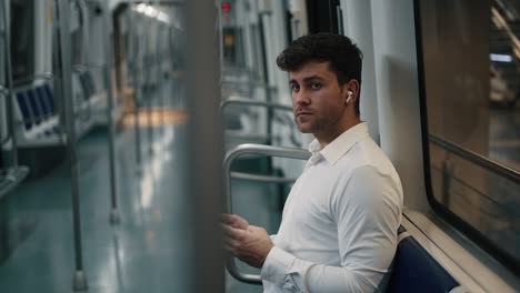 businessman with smartphone arriving on station