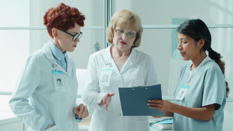 multiethnic female doctors having discussion in medical office