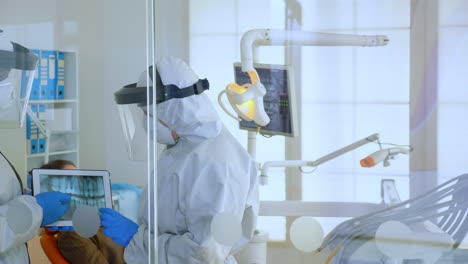 close up of dentists in ppe suit discussing in dental room