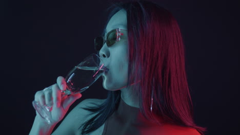 woman with champagne glass in neon light