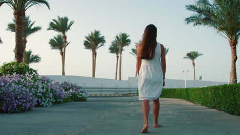 Teenage-girl-walking-at-exotic-park.-Young-woman-enjoying-summer-vacation.