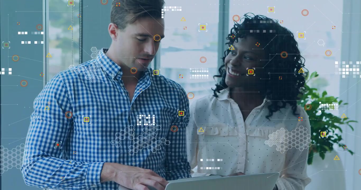 Woman pointing at laptop initiating hologram charts while man typing, highlighting tech data