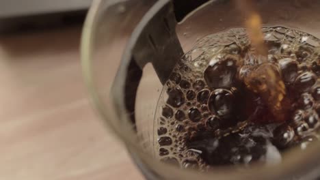 pouring fresh coffee into a pot