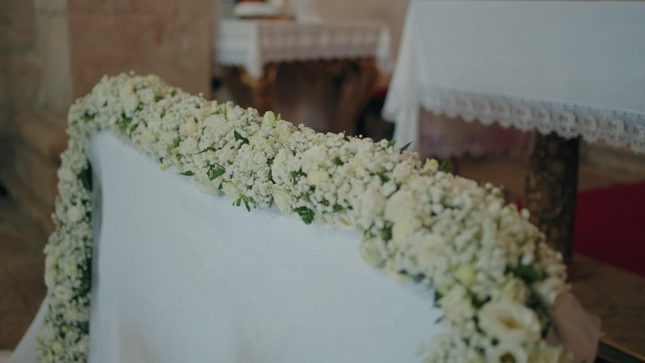 Closeup of delicate white flowers decorating a church altar for a ceremony