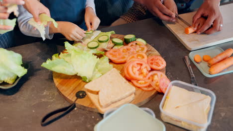 family preparing sandwiches with vegetables